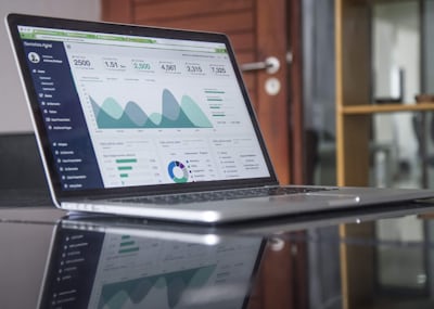 Laptop showing a green analytics dashboard