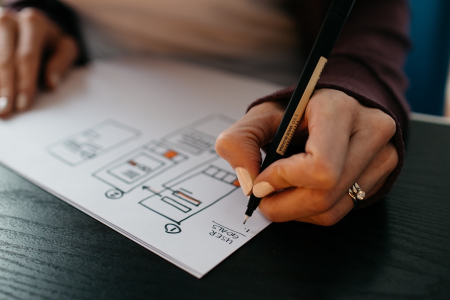 Hand sketching app screens on paper with a pen